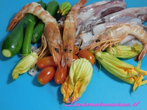 Pulire le verdure ed affettarle. Pulire poi i calamari e tagliarli a rondelle.